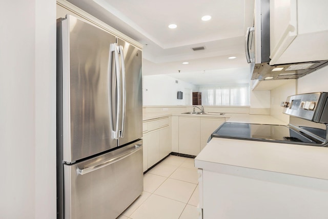 kitchen featuring appliances with stainless steel finishes, sink, and light tile patterned floors