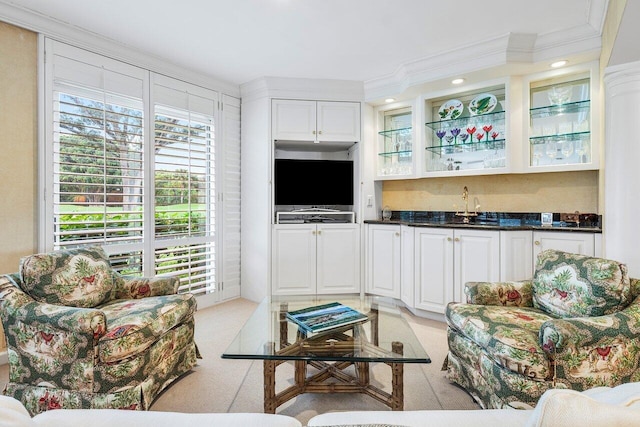 living room featuring ornamental molding and indoor wet bar