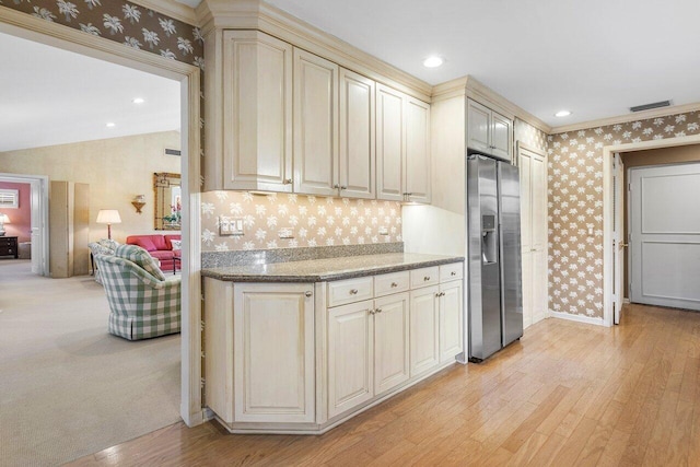 kitchen featuring stainless steel fridge with ice dispenser, light hardwood / wood-style flooring, crown molding, and cream cabinetry