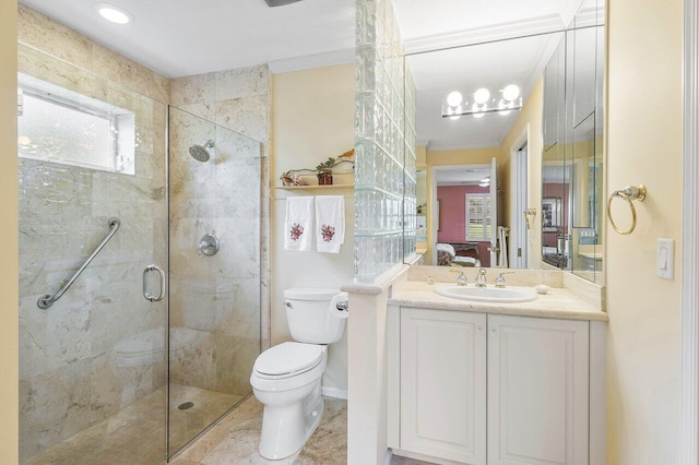 bathroom with toilet, vanity, and an enclosed shower