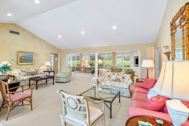 living room with light colored carpet and high vaulted ceiling