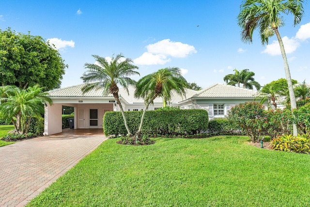 mediterranean / spanish house with a carport and a front yard