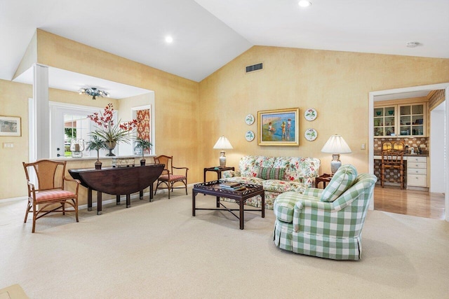 living room featuring carpet and lofted ceiling