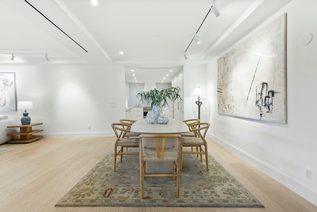 dining area featuring track lighting, baseboards, wood finished floors, and recessed lighting