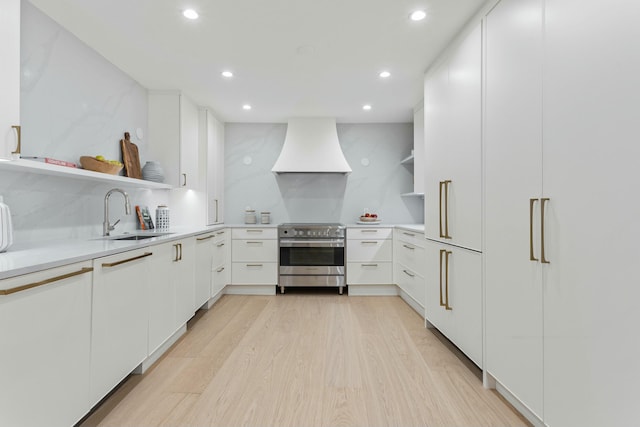 kitchen featuring light wood finished floors, open shelves, custom range hood, electric range, and a sink