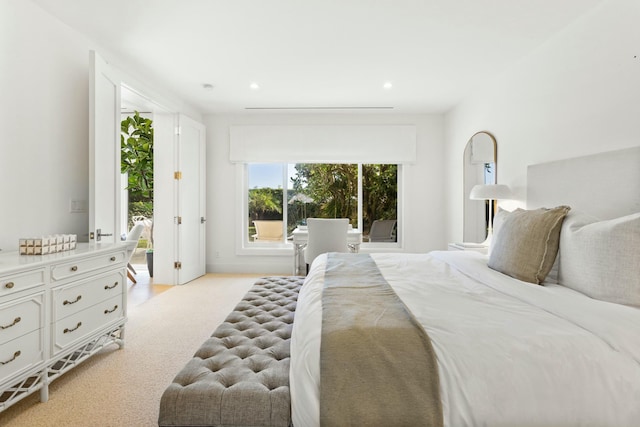 bedroom with access to exterior, recessed lighting, and light carpet