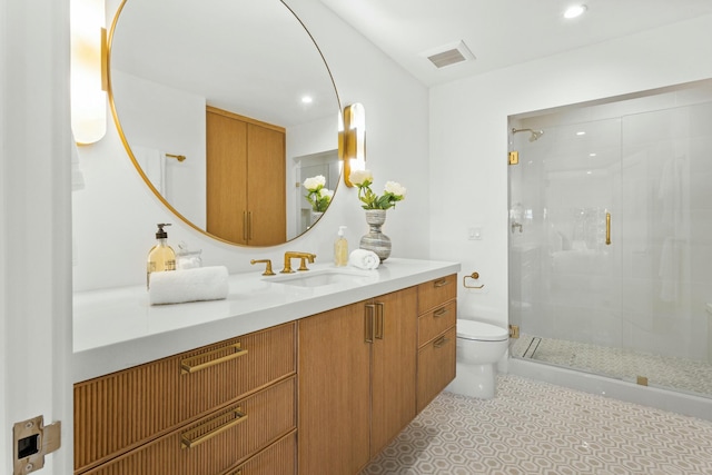 bathroom with toilet, recessed lighting, vanity, visible vents, and a stall shower