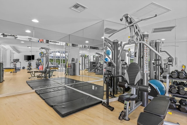 workout area with visible vents, wood finished floors, and recessed lighting