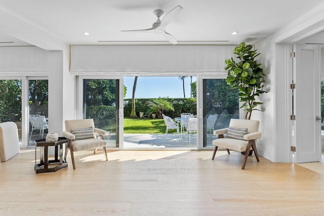 living area with ceiling fan, wood finished floors, and recessed lighting