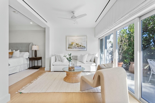 sitting room with wood finished floors and a ceiling fan