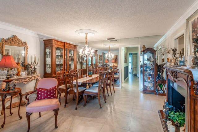 tiled dining area with a textured ceiling, a notable chandelier, and crown molding