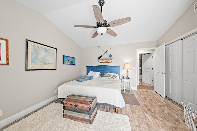 bedroom featuring ceiling fan, a closet, lofted ceiling, and hardwood / wood-style flooring