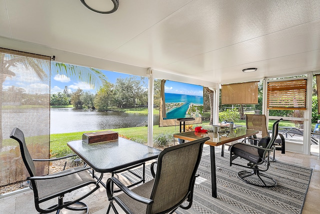 sunroom / solarium featuring plenty of natural light and a water view