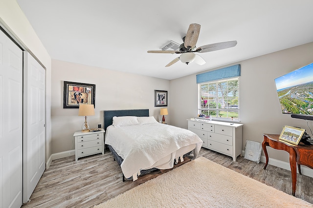 bedroom featuring hardwood / wood-style floors, ceiling fan, and a closet