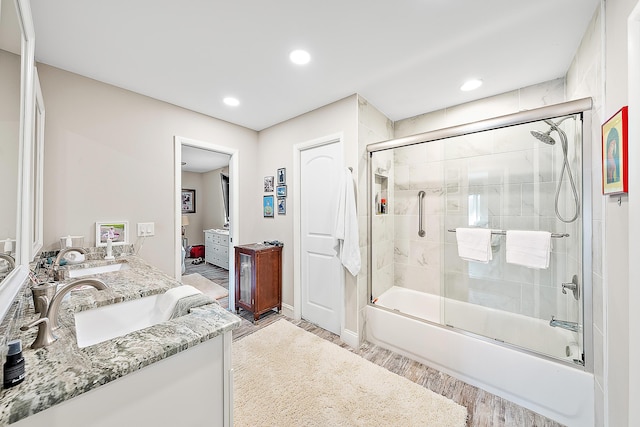 18352 Flagship Cir, Jupiter, FL 33458 - ensuite bathroom featuring bath / shower combo with glass door, double vanity, wood finished floors, and recessed lighting