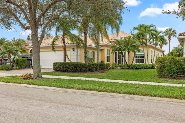 view of front of property with a garage and a front yard