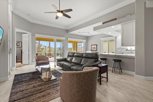 living room featuring track lighting, ceiling fan, and crown molding