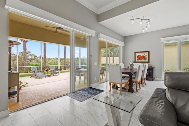 doorway to outside with ornamental molding and ceiling fan