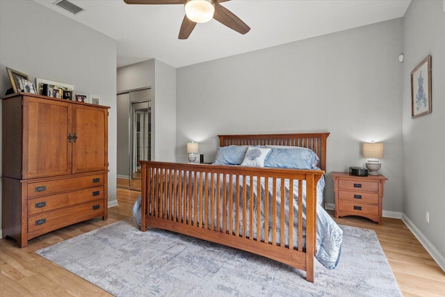 bedroom featuring light wood-type flooring, ceiling fan, and a closet