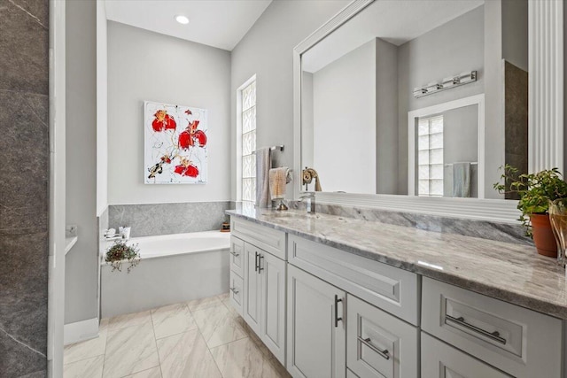 bathroom featuring a tub to relax in and vanity