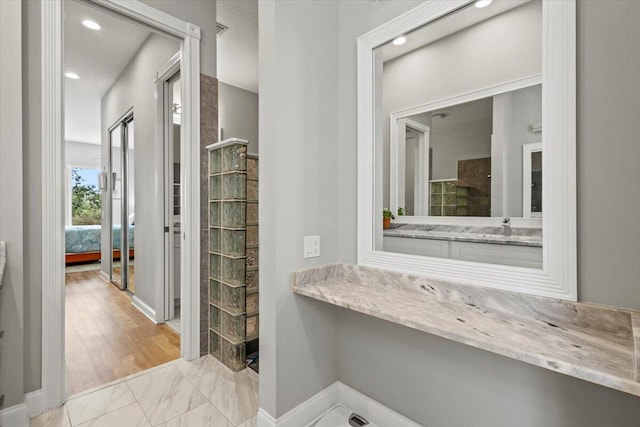 bathroom featuring a shower, sink, and hardwood / wood-style flooring