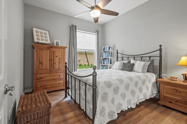 bedroom featuring ceiling fan and dark hardwood / wood-style floors