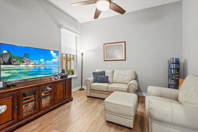 living room featuring ceiling fan and light hardwood / wood-style floors