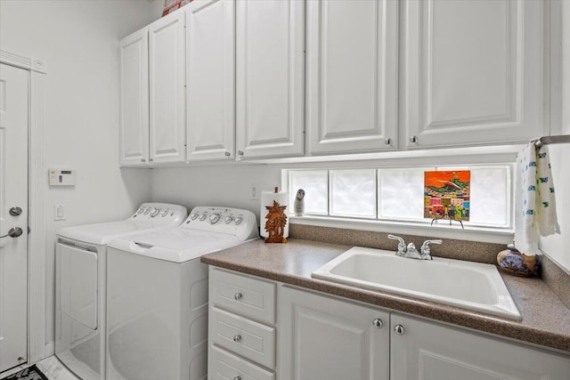 laundry room with a healthy amount of sunlight, separate washer and dryer, cabinets, and sink