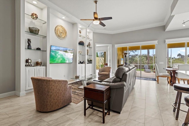 living room featuring built in shelves, ceiling fan, and crown molding