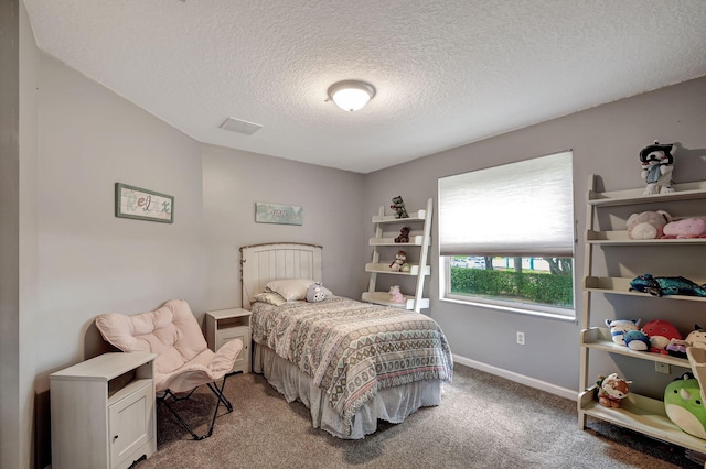 bedroom with a textured ceiling and carpet flooring