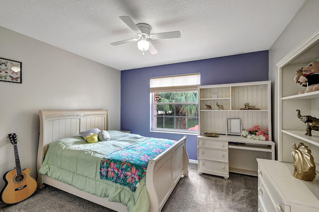 bedroom featuring a textured ceiling, dark colored carpet, and ceiling fan