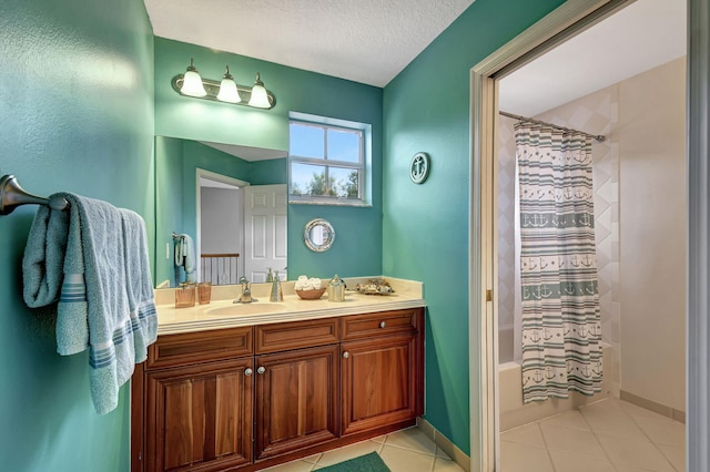 bathroom featuring vanity, shower / bath combo with shower curtain, a textured ceiling, and tile patterned floors