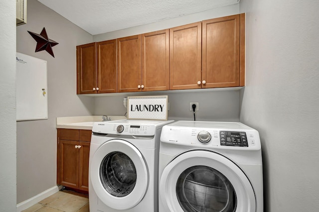 washroom with light tile patterned flooring, separate washer and dryer, a textured ceiling, cabinets, and sink