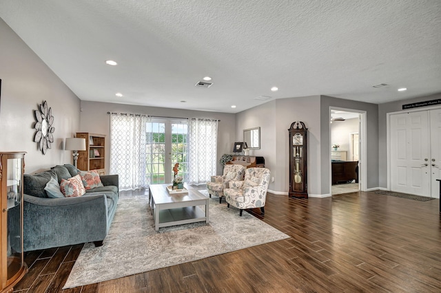 living room with dark hardwood / wood-style flooring, a textured ceiling, and ceiling fan