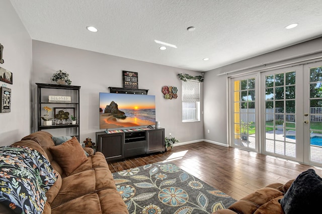 living room with dark wood-type flooring and a textured ceiling