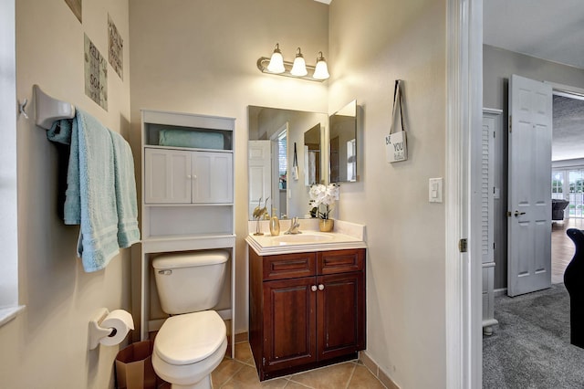 bathroom featuring tile patterned flooring, vanity, and toilet