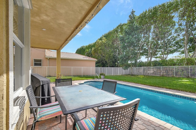 view of swimming pool with a lawn and a patio area