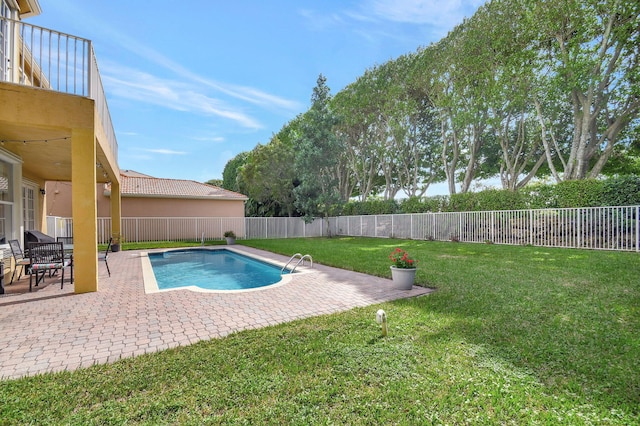 view of pool with ceiling fan, a patio, and a yard