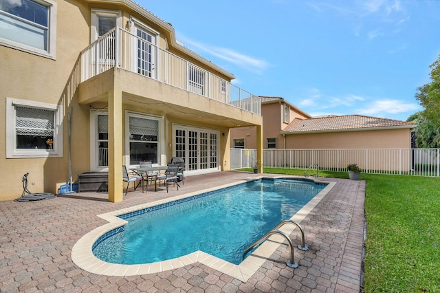 view of swimming pool featuring a lawn and a patio area