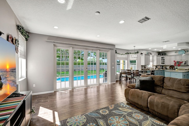 living room featuring dark hardwood / wood-style floors and a textured ceiling