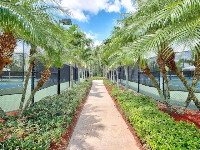 view of home's community with tennis court