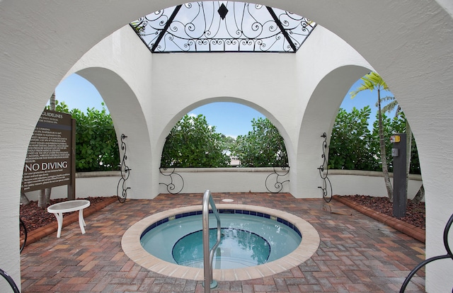 view of pool with a hot tub and a patio area