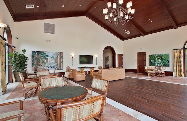 dining area with high vaulted ceiling, a notable chandelier, light wood-type flooring, and wooden ceiling