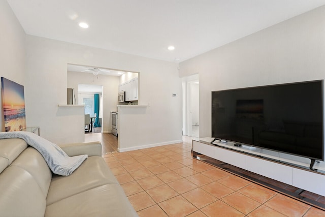 tiled living room with ceiling fan