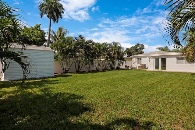 view of yard with a storage shed and central AC unit