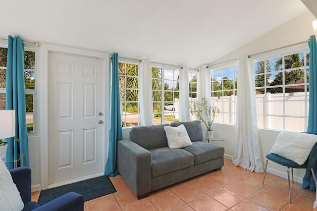 sunroom / solarium with a healthy amount of sunlight and vaulted ceiling