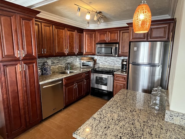 kitchen with stainless steel appliances, tasteful backsplash, a sink, and light stone countertops