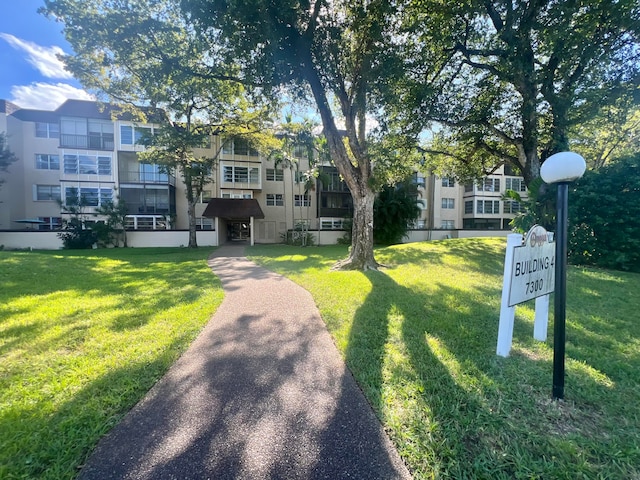 view of home's community featuring a lawn