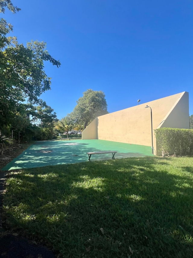 view of yard featuring basketball hoop