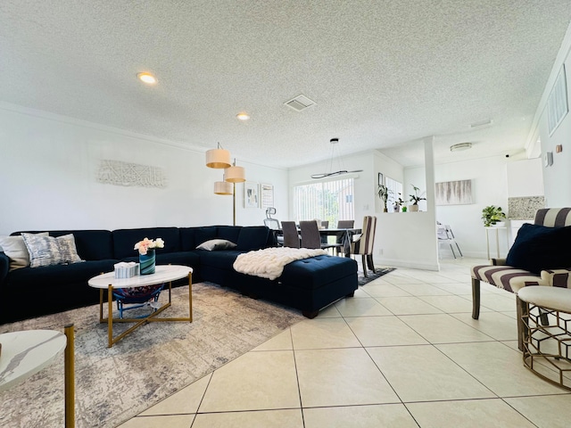 tiled living room featuring a textured ceiling and ornamental molding